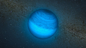 Künstlerische Darstellung des einsamen Planeten mit der astronomischen Bezeichnung CFBDSIR2149, wie er vor dem Zentrum der Milchstraße vorbeifliegt. Kein Stern bescheint ihn, deshalb ist er nur durch seine eigene, schwache Infrarot-Strahlung sichtbar. Für das menschliche Auge wäre er nur aus der Nähe in dunkelroter Farbe sichtbar. 