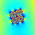 Auf einem Wasserwirbel schwimmende Mikroscheiben setzen sich selbstständig zur einer symmetrische Struktur zusammen. 
